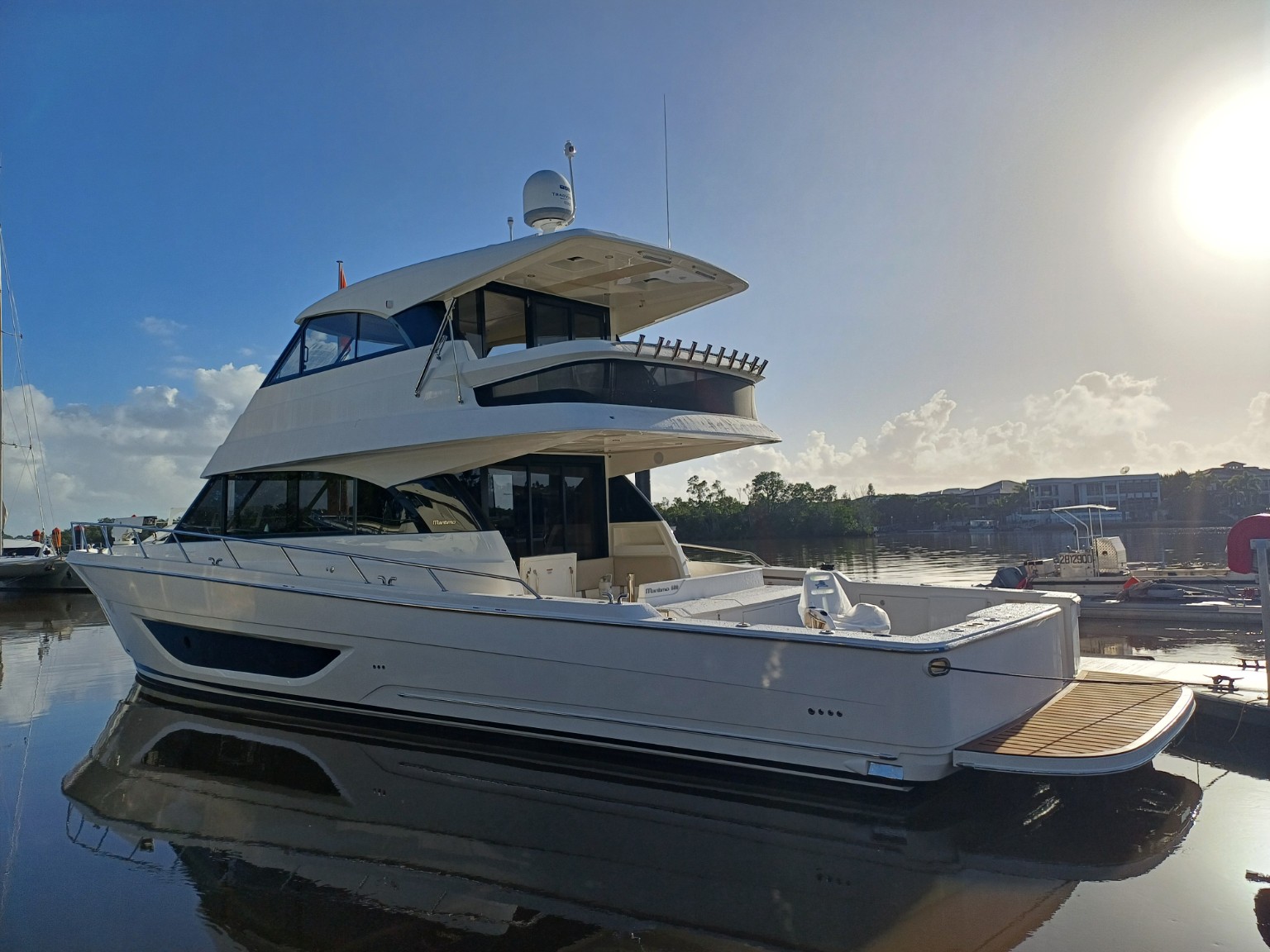 White Maritimo motor yacht berthed in a marina